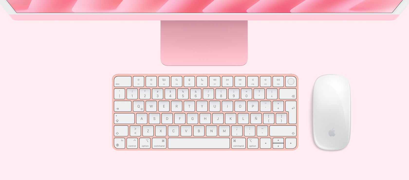 Vista panorámica de un iMac rosa con mouse y teclado a juego
