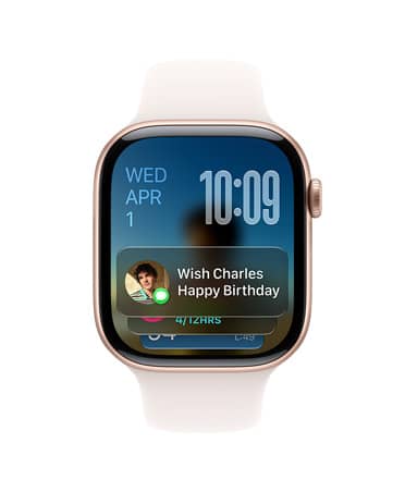 Apple Watch Series 11, สีโรสโกลด์พร้อมสายสีชมพูบลัช, หน้าปัดแสดงวันที่ที่ด้านซ้ายบน, เวลาที่ด้านขวาบน และวิดเจ็ตข้อความที่ด้านล่าง
