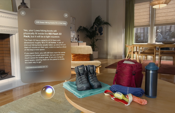 Apple Vision Pro view, a conversation with Siri about hiking boots fitting in a backpack hovers above Siri and to the left of a pair of hiking boots and other outdoor gear