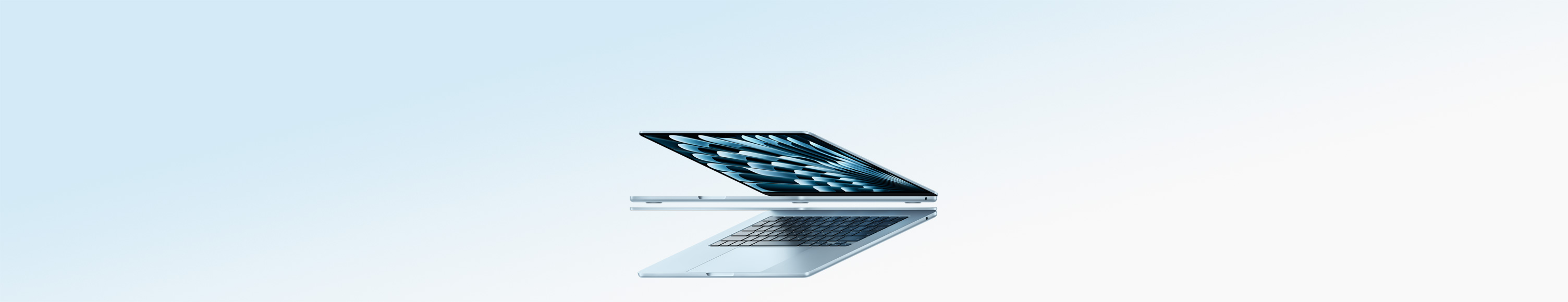 Two open MacBook Air laptops in sky blue color forming arrow shape, emphasizing narrow profile